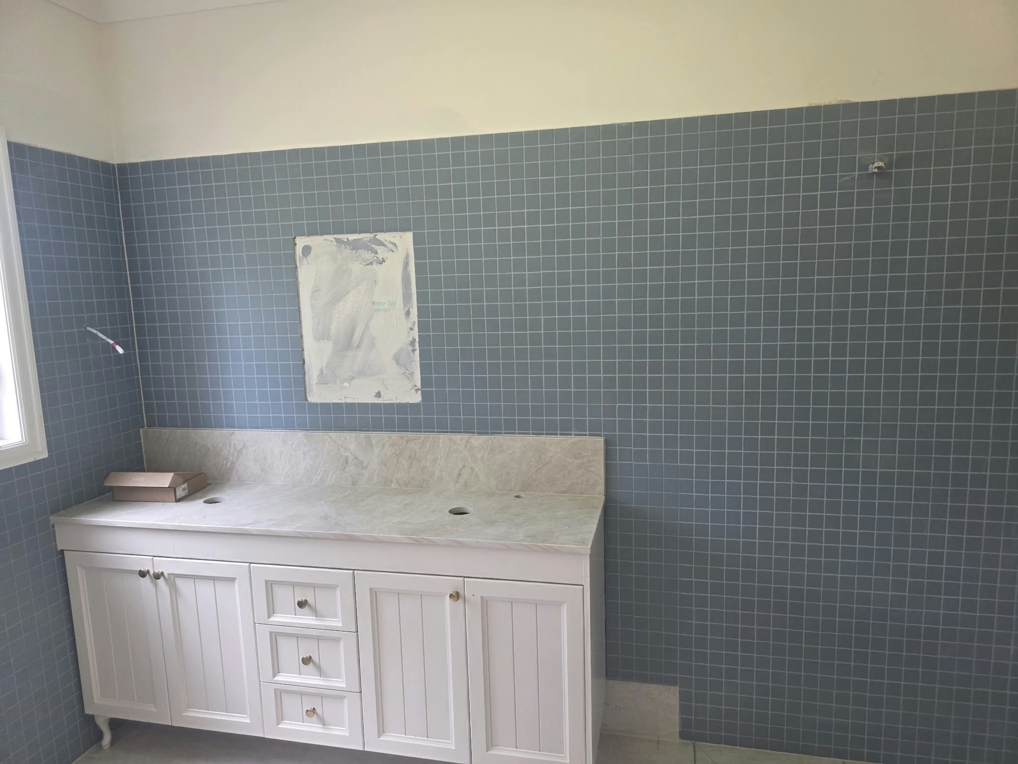 Bathroom with blue mosaic feature wall and vanity